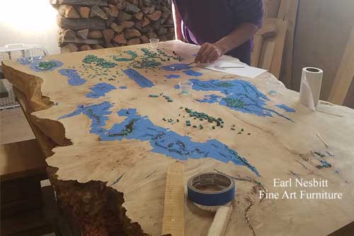 Earl placing turquoise in cluster burl maple coffee table